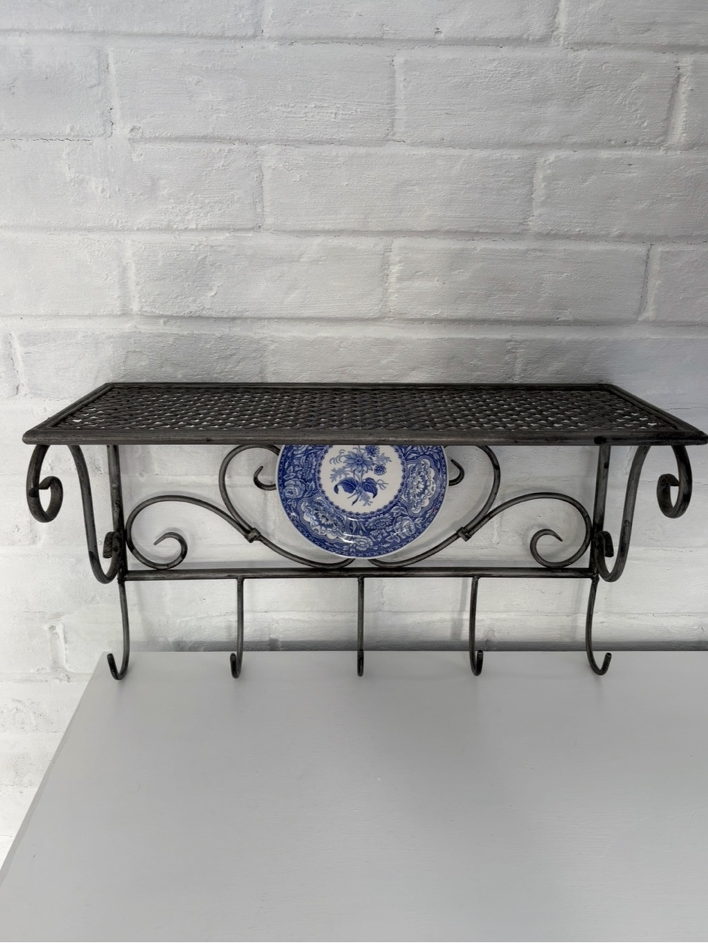 Black Wrought Iron Wall Shelf with Hooks and Decorative Blue Plate - Picture 3 of 12